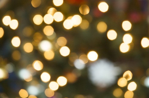 Out-of-focus image of soft, glowing lights creating a warm, festive atmosphere.