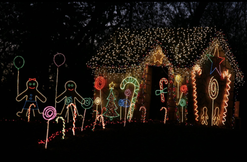 A festive display of colorful Christmas lights featuring a gingerbread house, candy canes, and whimsical characters.