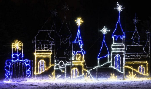 A whimsical display of illuminated castle towers and stars in blue and yellow lights against a dark background.