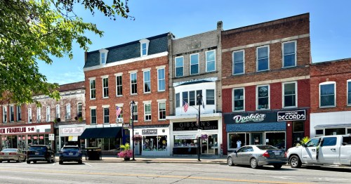 Downtown Oberlin, Ohio, showing historic buildings and storefronts under a beautiful blue sky