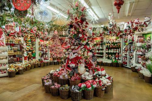 A festive store display filled with Christmas decorations, including a decorated tree and various holiday-themed items.