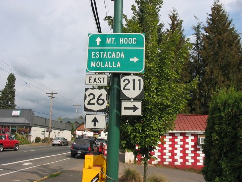 Road sign indicating directions to Mt. Hood, Estacada, and Molalla, with highway numbers 26 and 211.