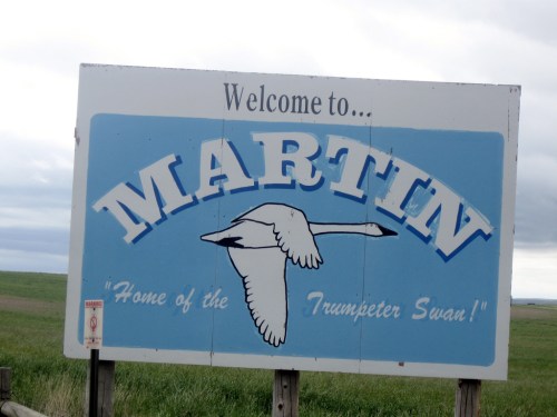 Sign welcoming visitors to Martin, featuring a drawing of a Trumpeter Swan and the text "Home of the Trumpeter Swan!"