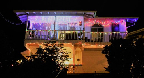 A house decorated with colorful lights for the night, showcasing a festive atmosphere.