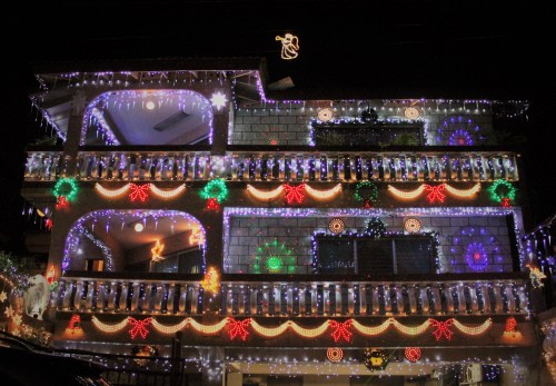 A beautifully decorated house at night, adorned with colorful lights and festive ornaments for the holiday season.