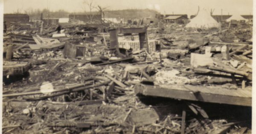 A desolate landscape of debris and ruins, remnants of buildings scattered across the ground.