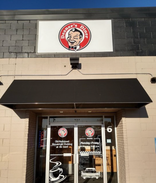 Exterior of Deaner's Diner, featuring a sign with a smiling chef logo and a welcoming entrance.