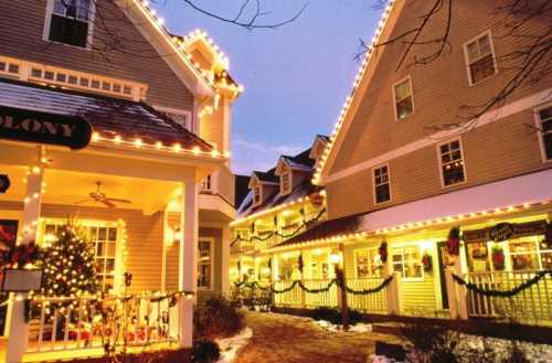 Charming buildings adorned with festive lights and decorations, creating a cozy winter atmosphere.