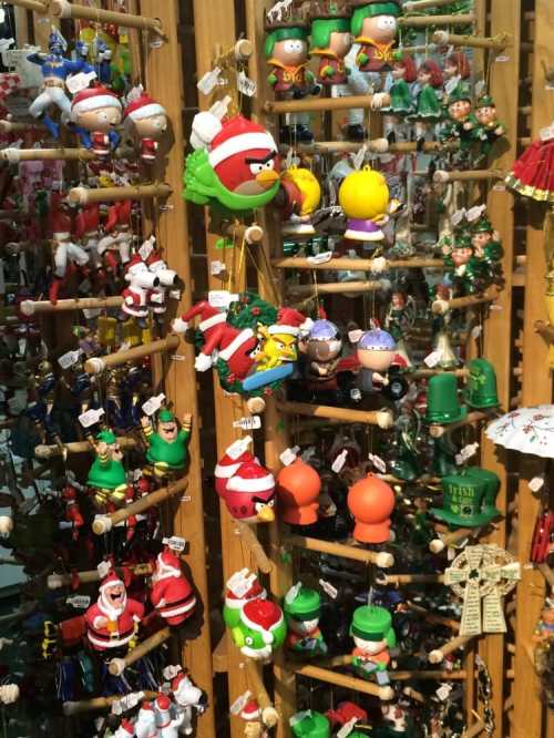 A colorful display of various holiday ornaments, including characters in festive attire and Christmas decorations.