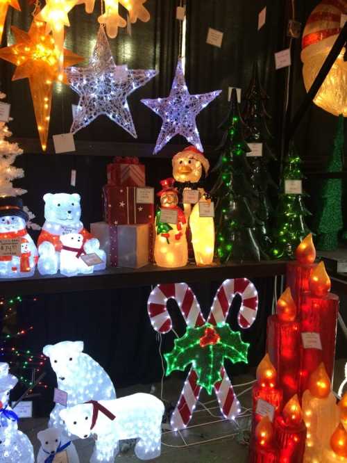 A festive display of colorful holiday lights, including stars, trees, bears, and candy canes.