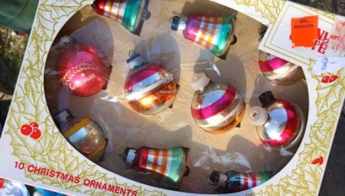 A box containing 10 vintage Christmas ornaments in various colors and designs, including bells and round shapes.