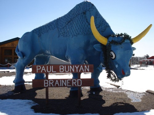 A large blue statue of a bison wearing a wreath, with signs reading "Paul Bunyan" and "Brainerd" in the foreground.
