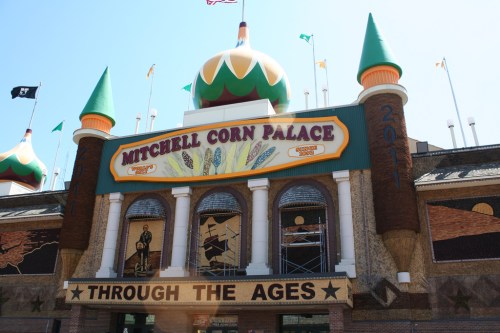Exterior of the Mitchell Corn Palace, featuring colorful turrets and a sign reading "Through the Ages."