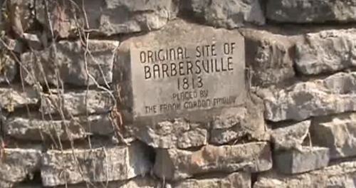 Stone marker on a wall reading "Original Site of Barbersville 1813, Placed by the Fort Gratiot Chapter."