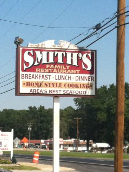 Sign for Smith's Family Restaurant, featuring breakfast, lunch, dinner, and home-style cooking with a focus on seafood.