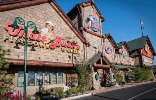 Exterior of Uncle Buck's Fish Bowl & Grill, featuring a rustic design with signage and landscaping.