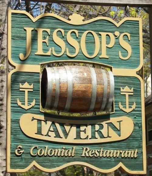 Sign for Jessop's Tavern featuring a wooden barrel and nautical symbols, with "Tavern & Colonial Restaurant" below.