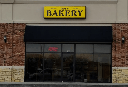 A storefront with a sign reading "Jeff's Bakery" and an illuminated "OPEN" sign in the window.