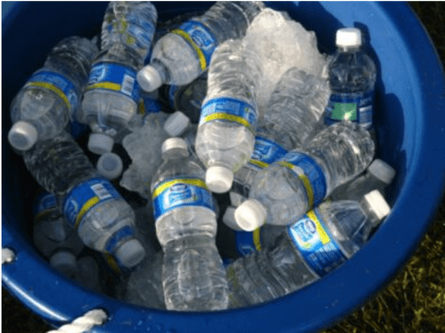 A blue bucket filled with ice and numerous water bottles.