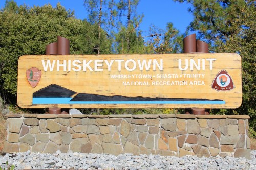 Sign for Whiskeytown Unit, featuring the names of Whiskeytown, Shasta, and Trinity National Recreation Area.