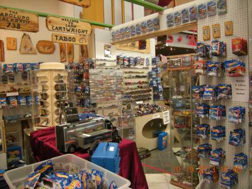 A colorful store interior filled with toy cars, collectibles, and display cases, creating a vibrant shopping atmosphere.