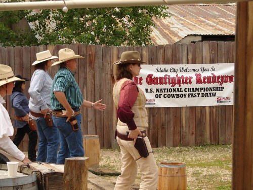 Participants in cowboy attire prepare for the U.S. National Championship of Cowboy Fast Draw event.