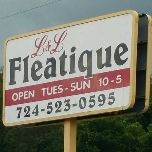 Sign for L & L Fleatique, open Tuesday to Sunday from 10 AM to 5 PM, with phone number 724-523-0595.