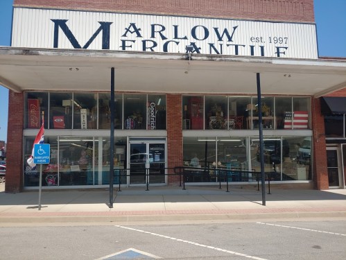Front view of Marlow Mercantile, a storefront with large windows displaying various items, established in 1997.
