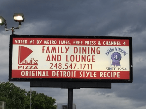 Sign for Louis Pizza featuring "Family Dining and Lounge," award-winning since 1954, with contact number and accolades.