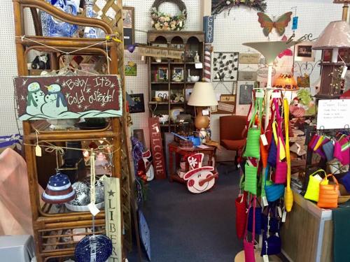A cozy shop filled with colorful crafts, decorations, and furniture, creating a warm and inviting atmosphere.