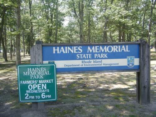 Sign for Haines Memorial State Park in Rhode Island, featuring information about the farmers market hours.