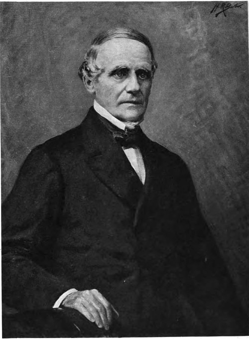 Portrait of a middle-aged man in formal attire, seated with a serious expression against a textured background.