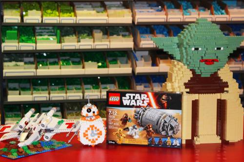 A colorful display of LEGO Star Wars sets, featuring Yoda, a BB-8 figure, and a starfighter model.