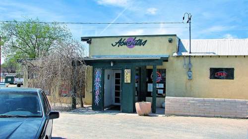Exterior of a restaurant named "Aloftara," featuring a welcoming entrance and an "Open" sign on a sunny day.