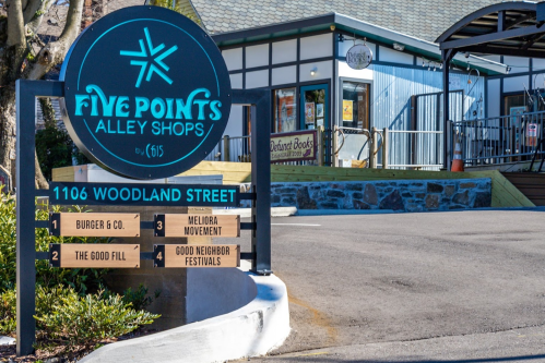 Sign for Five Points Alley Shops at 1106 Woodland Street, featuring businesses like Burger & Co. and The Good Fill.