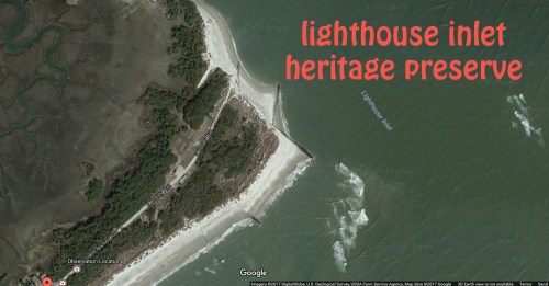 Aerial view of Lighthouse Inlet Heritage Preserve, featuring sandy shores and surrounding greenery along the coastline.