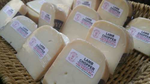 A basket filled with slices of cheese labeled "Lamb Chopper," showcasing various pieces with packaging.