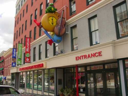 Colorful entrance of a children's museum featuring playful decorations and a large musical note sign.