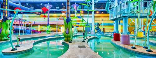 Colorful indoor water park featuring winding pools, playful water features, and vibrant decor.