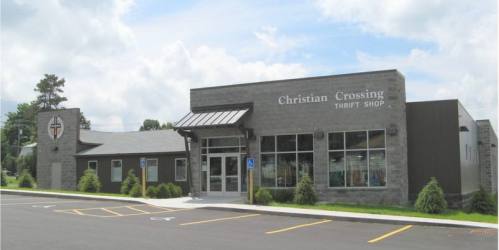 Exterior view of Christian Crossing Thrift Shop, featuring a modern building with large windows and a welcoming entrance.