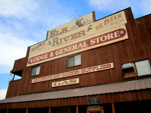 Signage of the Elk River Lodge and General Store, featuring rooms, ice cream, groceries, and gas services.