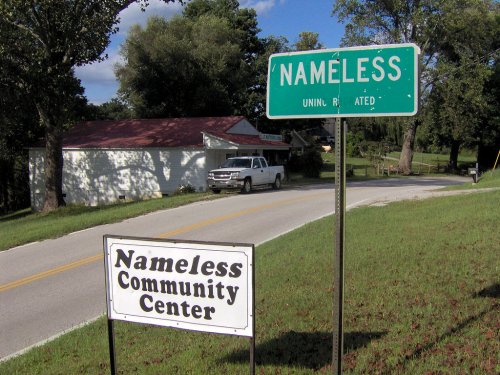 A road sign for "Nameless" and a sign for the "Nameless Community Center" near a rural road.