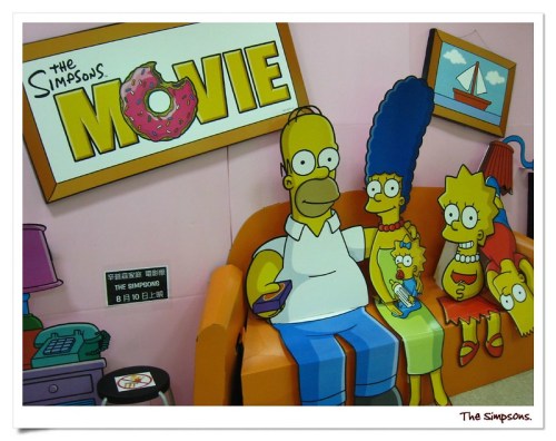 A colorful display featuring the Simpson family sitting on a couch, promoting "The Simpsons Movie."
