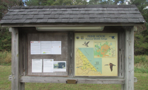 Information board at Prime Hook National Wildlife Refuge, featuring maps and educational materials about the area.