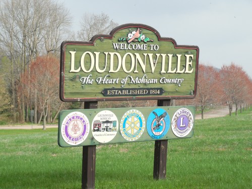 Welcome sign for Loudonville, Ohio, featuring local organization logos and the phrase "The Heart of Mohican Country."