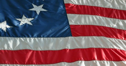 Close-up of the American flag, featuring red and white stripes with a blue field and white stars.