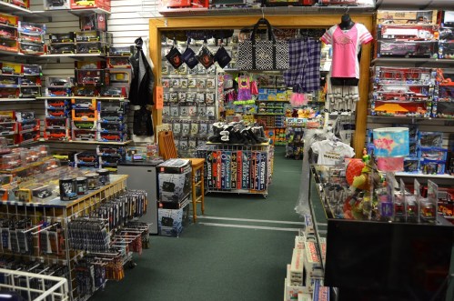 A colorful toy store filled with shelves of model cars, action figures, and various collectibles.