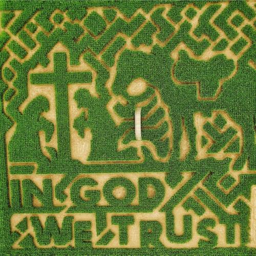 A green grass design featuring the text "In God We Trust" alongside a cross and animal silhouettes.