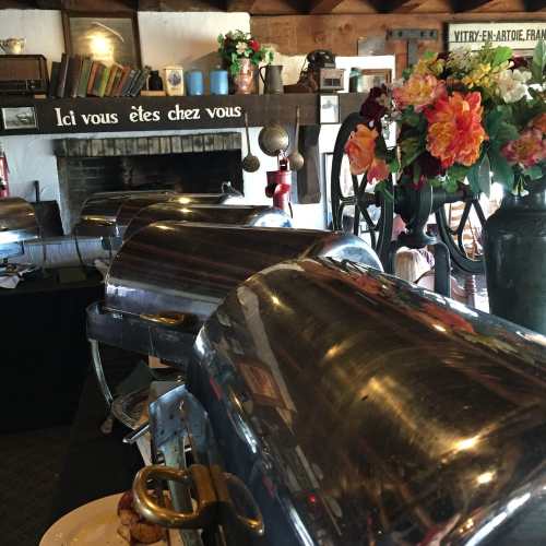 A cozy dining area with buffet trays, flowers, and a fireplace, creating a welcoming atmosphere.
