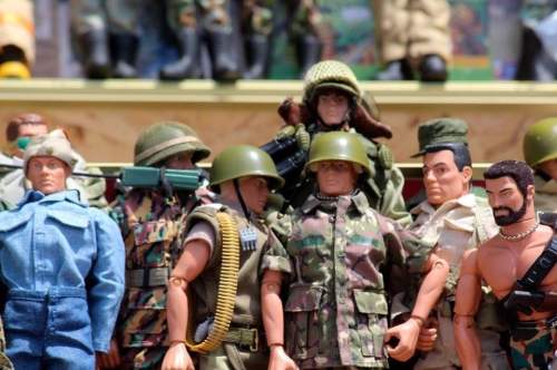 A collection of action figures dressed in military uniforms, showcasing various styles and accessories.